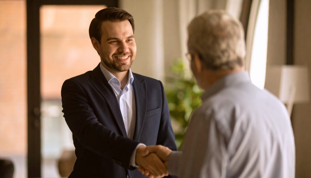Handshake between buyer and seller agreeing to a payment plan for a business sale