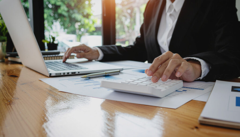 Business owner reviewing financial records to prepare a plumbing company for sale.