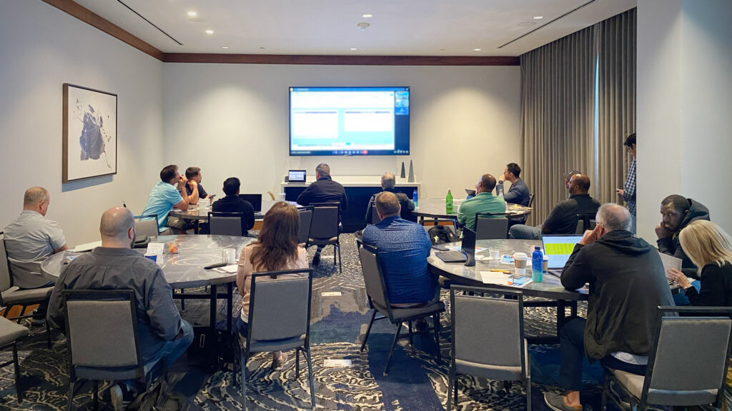 Participants reviewing live business acquisition deals during a session at Acquira’s Fort Lauderdale workshop