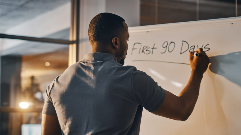 Small business owner analyzing performance metrics during post-acquisition transition