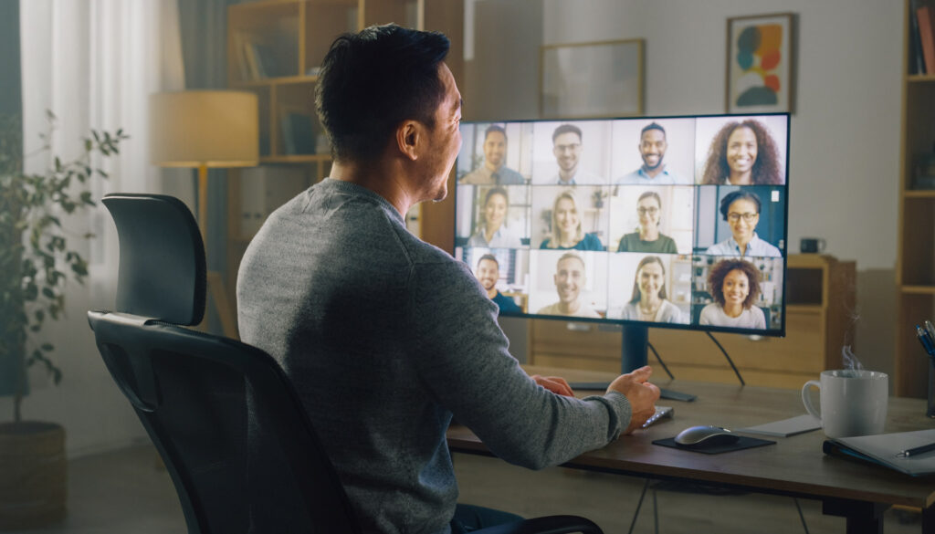 New owner managing distributed team through virtual meeting after acquisition