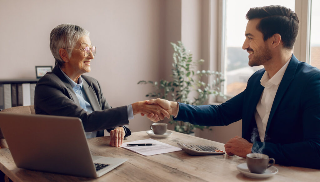 Two professionals discussing deal structure terms over financial documents